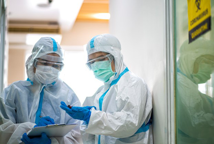 Asian doctor checking coronavirus or covid-19 infected patient in quarantine room